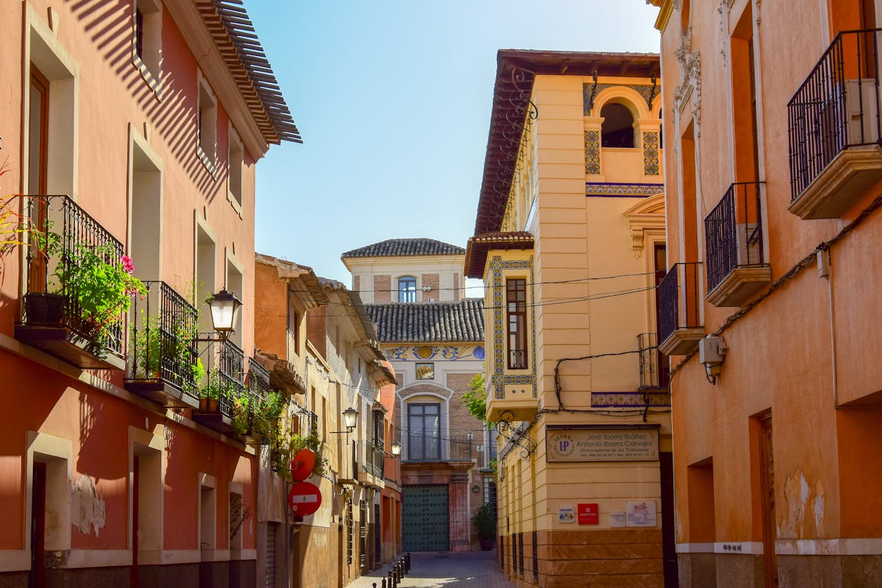 Picturesque street view in Mula, Murcia, Spain with colorful buildings and balconies.